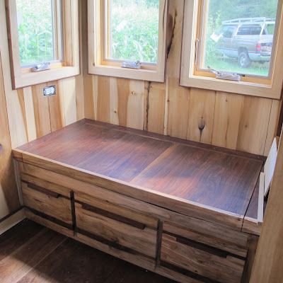 Built in bench for storage. Perhaps a small slab of wood could be pulled down fo