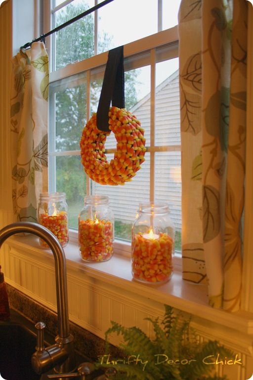 Fill Mason jars with Candy Corn & stick a tea light in there. Fall decor alo