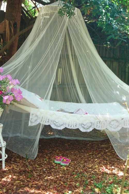 Hammock and mosquito netting hung on trees in back yard for a relaxing retreat.