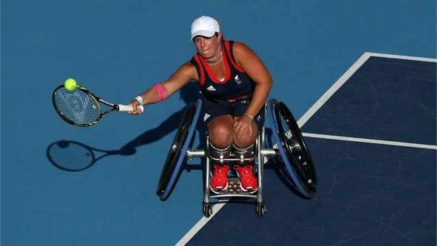 Lucy Shuker plays a forehand with partner (out of frame) Jordanne Whiley of Grea