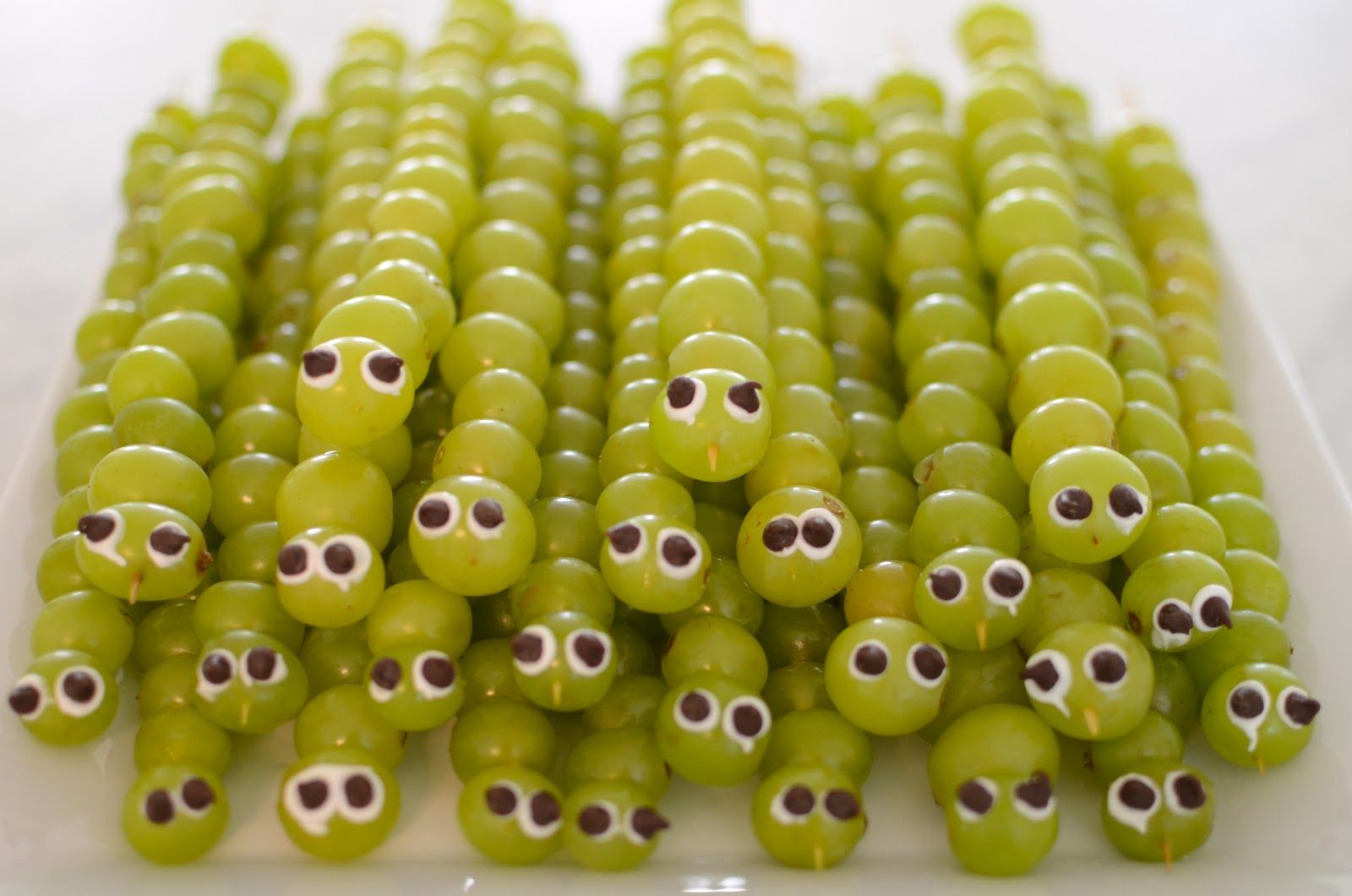So cute! Grape caterpillars with frosting/chocolate chip eyes.