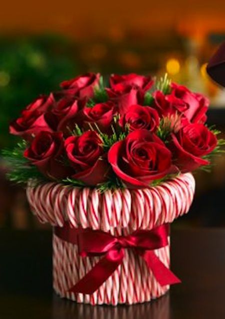 Stretch a rubber band around a cylindrical vase, then stick in candy canes until