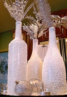 Wine bottles centerpieces. Simply spray paint, spray with adhesive and roll in e