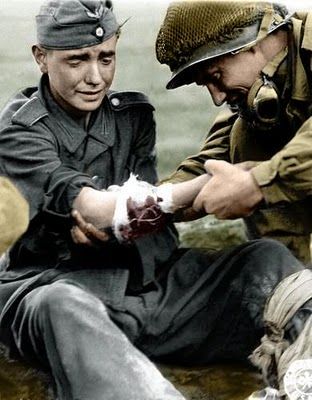 A young German soldier treated by an American medic.