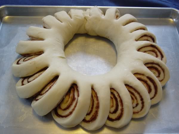 Christmas cinnamon roll wreath. Frosting in the middle for pull apart and dip!