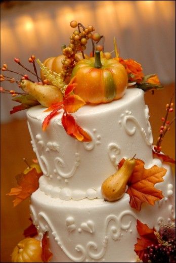 For this fall wedding, the cake is decorated with fall leaves, gourds, pumpkins,