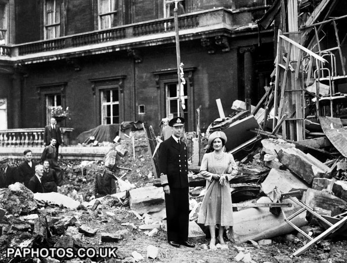 The King and Queen stand amid the bomb damage at Buckingham Palace during WWII.