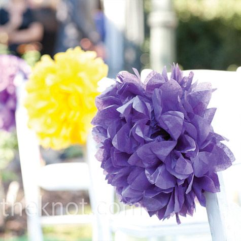 The bride added bursts of purple and yellow to the wedding aisle with large tiss