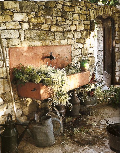 stone sink and watering cans