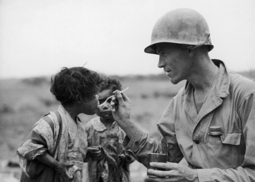 A US Marine feeds children on the island of Okinawa.
