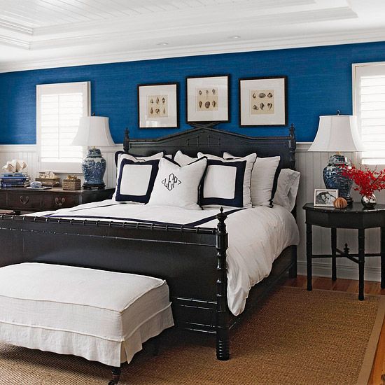 Blue room with white trim and black bed