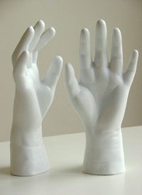 Fill a pair of small rubber gloves with Plaster of Paris and set the pose you wa
