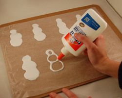 Make snowmen out of glue.  Decorate with paper, glitter etc. Then let dry on wax