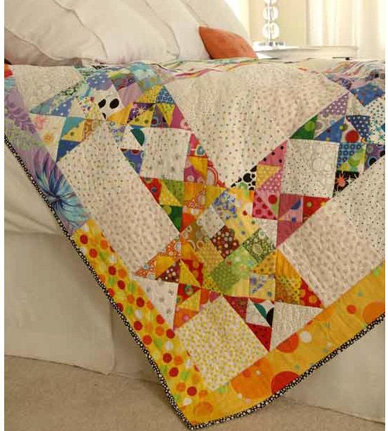 Scrap quilt made with vibrant fabrics