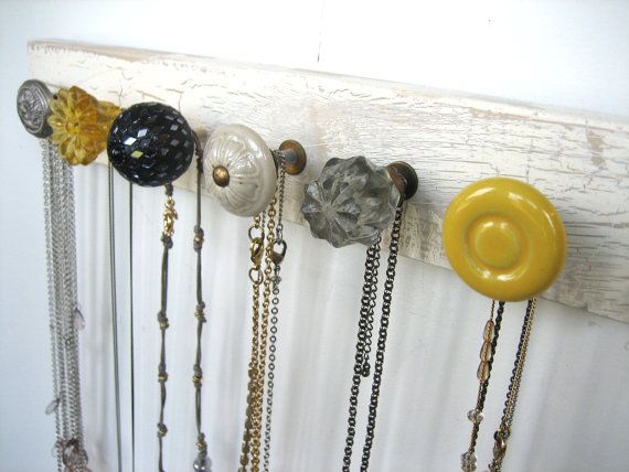 Use cute door nobs on rustic wood to hang jewelery
