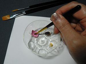 Use the bottom of a plastic bottle for a paint tray