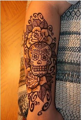 sugar skull and flowers arm tattoo