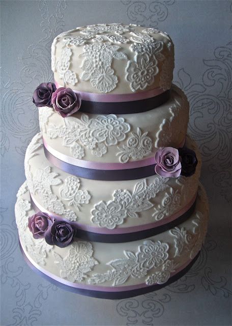 Oh so pretty lace wedding cake with purple sugar roses. For more purple wedding