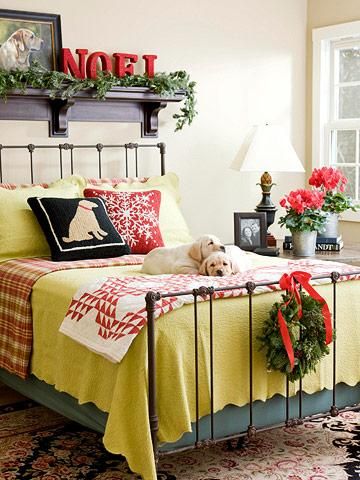 Red and green bedding paired with fresh greens create festive Christmas decor. C