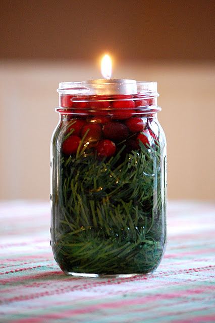 So simple and pretty. Mason jar, greenery, cranberries, water, tea light.