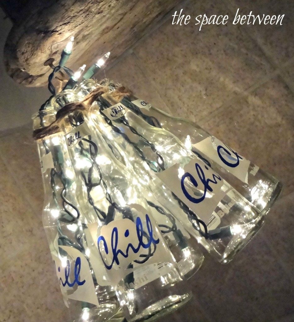 Wine bottles + christmas lights = upcycled chandelier.