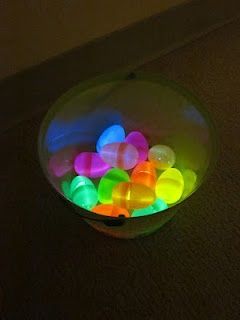 Put small glow stick in plastic eggs. Then hide them in the house and turn off t