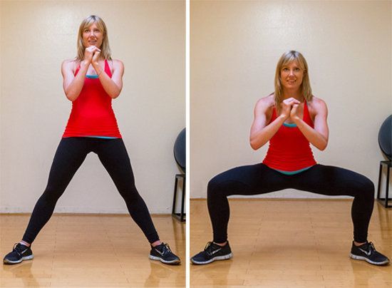 Wide squats target your butt and inner thighs.    Hold your hands together in fr