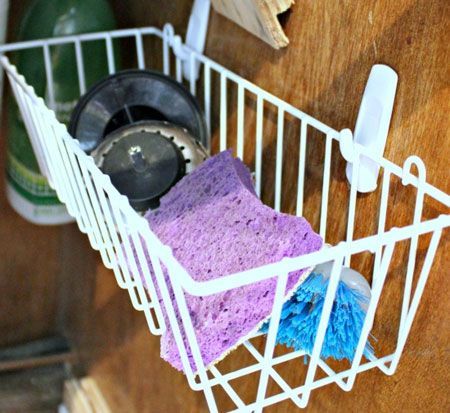 Command hooks hold wire basket for additional storage under the sink