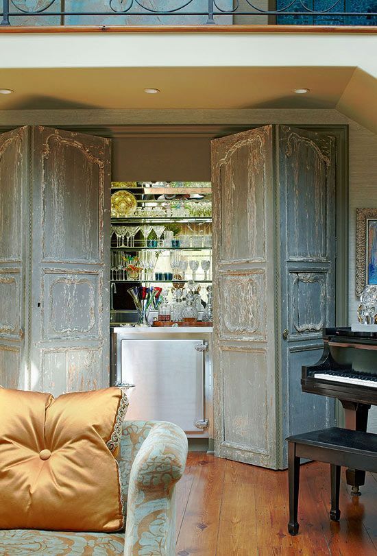 Salvaged French doors conceal bar