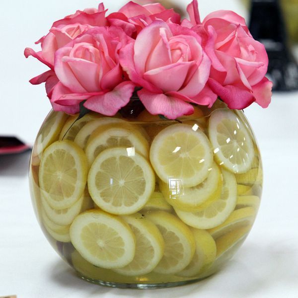 Top a bowl of lemon slices with bright roses for an easy DIY centerpiece