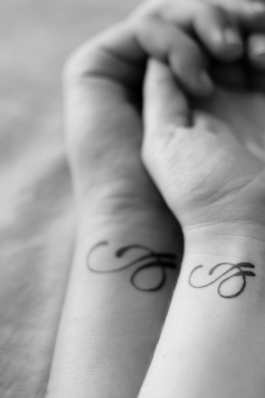 Couples tattoo. The design is the first letters of their names intertwined (e an