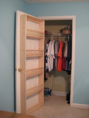 Shelves attached to the inside of a closet door for shoes, purses & accessor