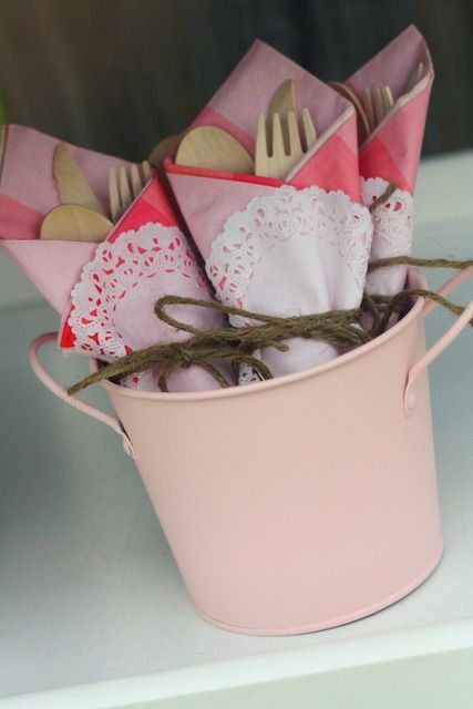 Wrap doilies around utensils and light pink napkin, tie with ribbon.
