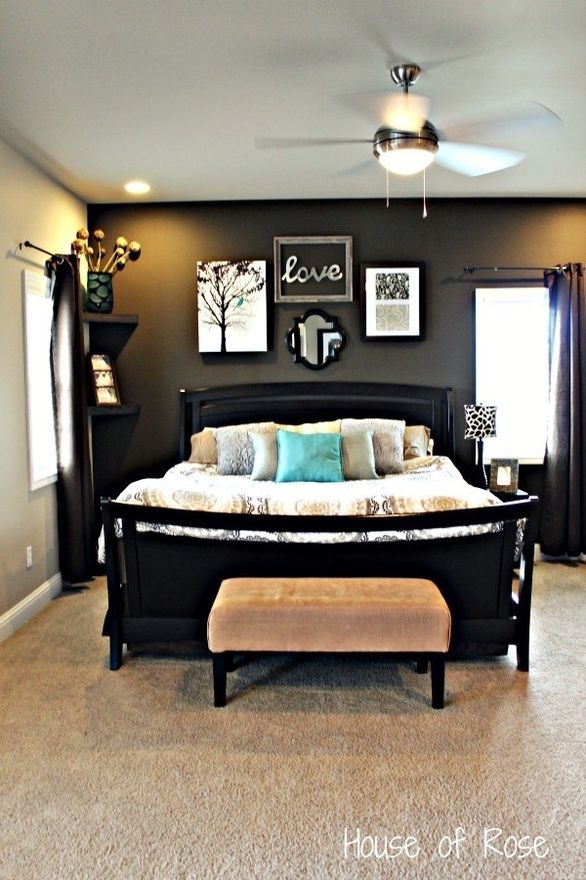 love the black accent wall with the black bed frame!!
