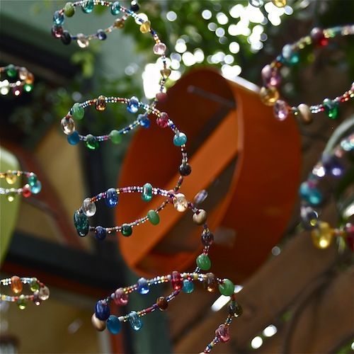Garden Art –Beads strung on bracelet memory wire and hung w/ a bell on the end-
