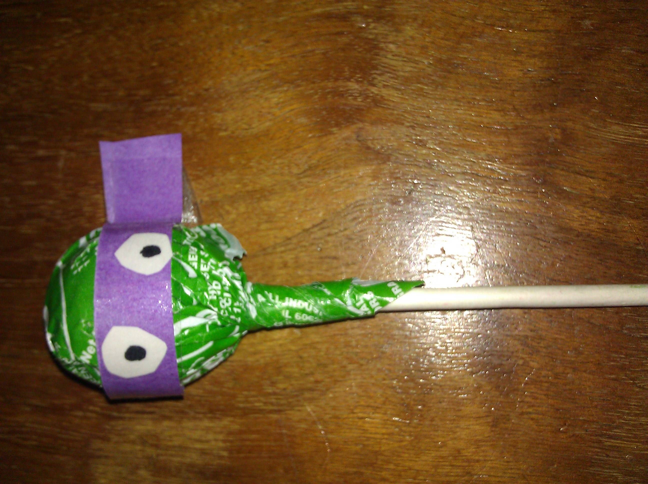 Use a green tootsie roll pop and wrap a bandanna made of construction paper arou
