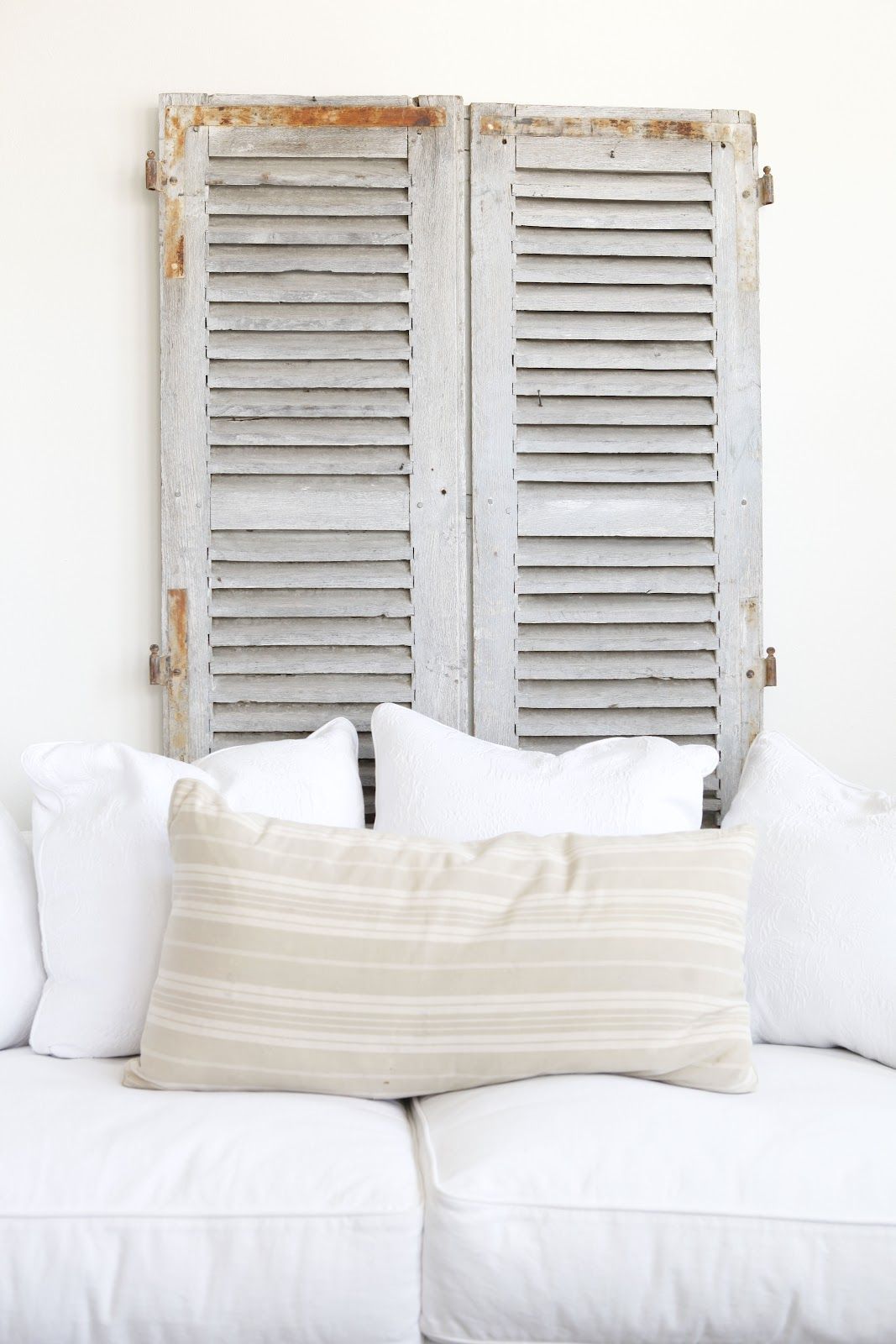 old shutters behind a couch   |   DustyLu Interiors