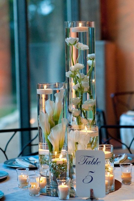 A few great vases, a stem of flowers, and floating candles – doesnt cost much to