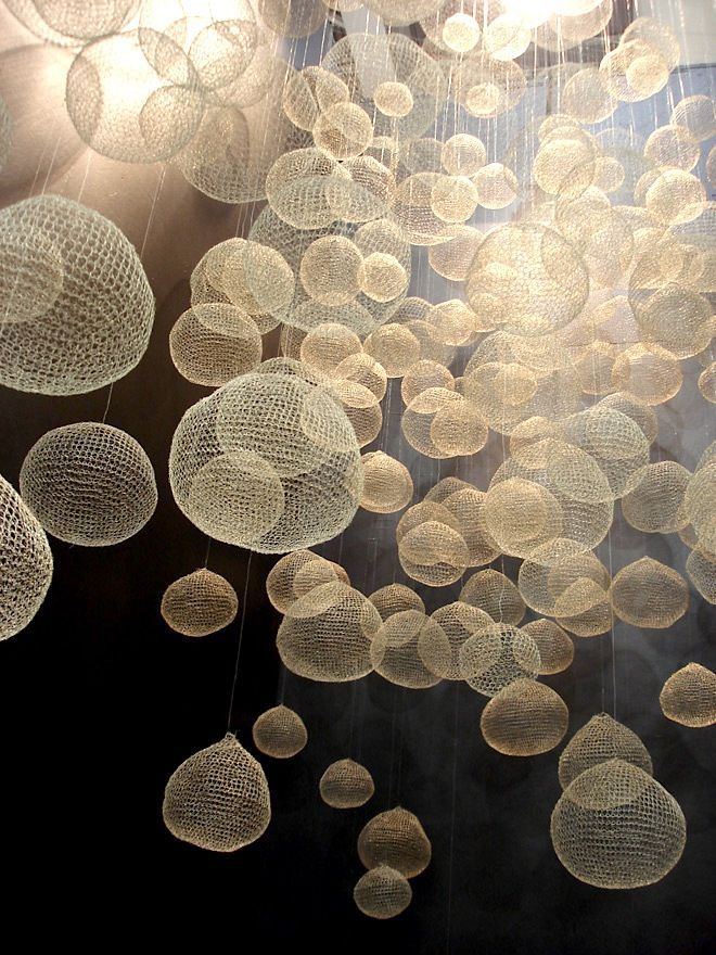 Crocheted (?) forms looking like a host of jellyfish – beautiful. Need to do a h