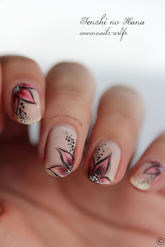 floral motif in pinks and black over nude pink manicure