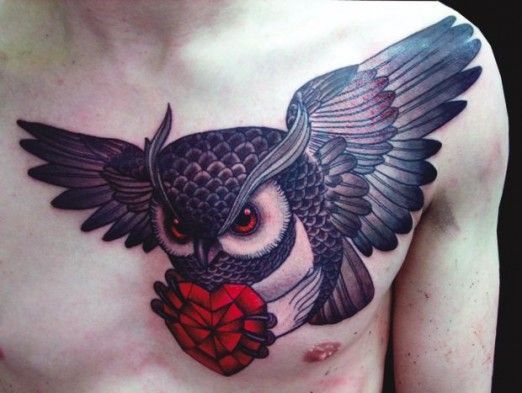 Owl carrying a ruby heart chest piece by Inma #InkedMagazine #ruby #owl #tattoo