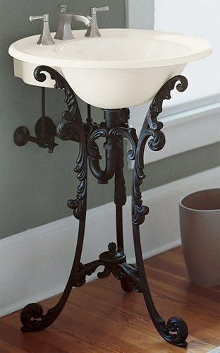 A black iron pedestal sink that brings the charm of ornate antique furniture.