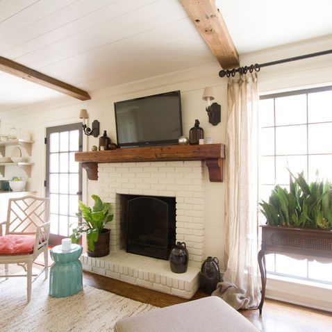 White Brick Fireplace – Love the added mirrored lights, natural wood hearth top