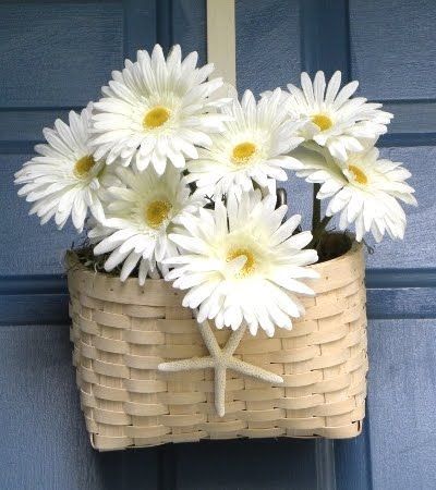 Cute front door decoration for summer.  Id pick some much brighter flowers, but