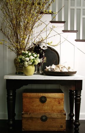 entry way table with room for shoes underneath and keys on top in a basket perha