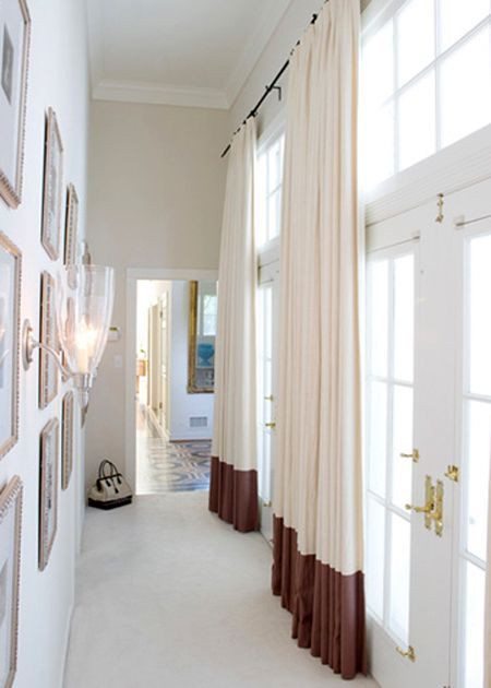 Framed artwork on the walls and gorgeous drapery framing large windows would mak