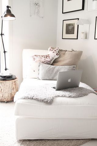 Cozy chaise reading nook. Sheepskin, pillows, reading lamp, and of course, a Mac