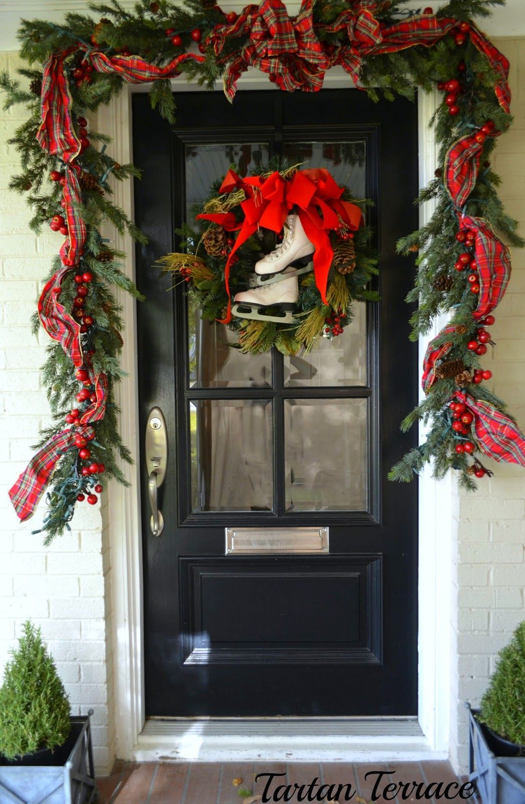 The white skates & red ribbon stand out against the black door ~ via Enchanted H