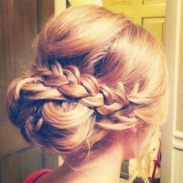 A low slung bun with a thick braid wrapped over makes this fab hairdo the perfec