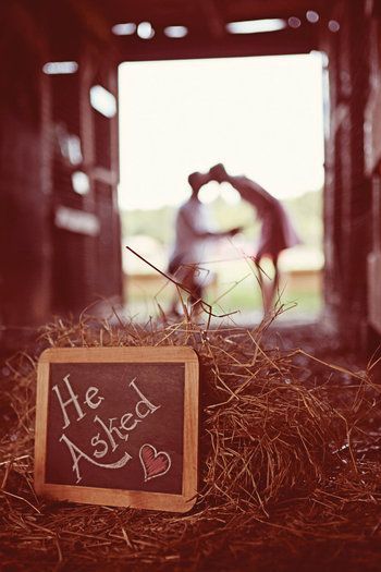 chalkboard message save the date with couple in the background out of focus. such a sweet